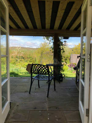 Open doors with coffee on the table Picture of open french doors and a view